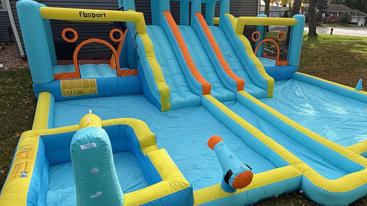 Inflatable water park with a double slide, bounce area, splash pools and water cannons
